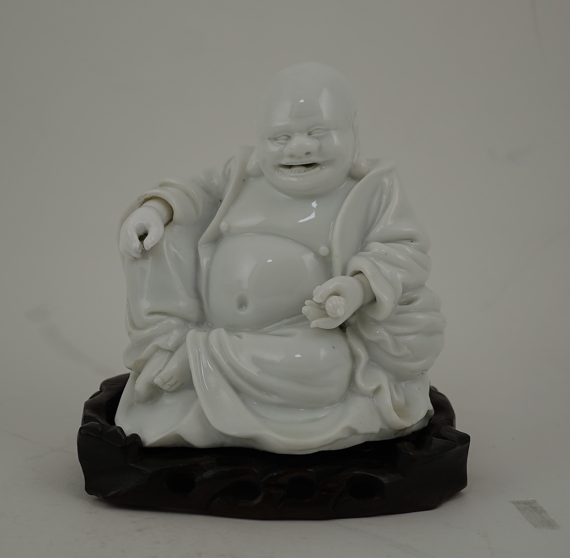 A Chinese blanc-de-chine seated figure of Budai, 18th/19th century